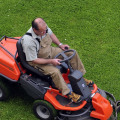 What's the difference between a riding lawn mower and a tractor?